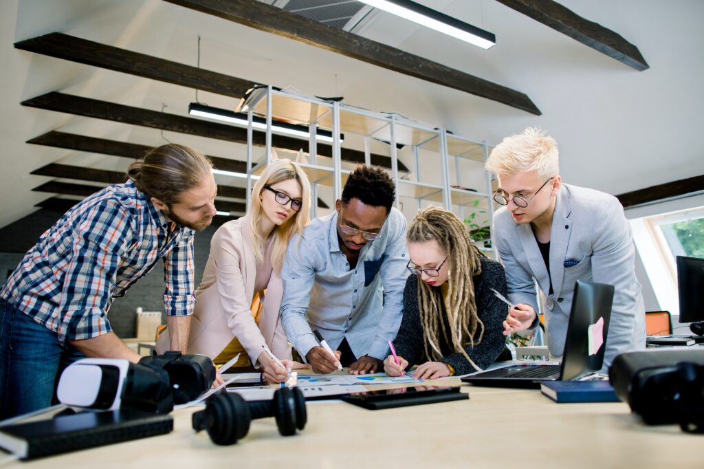 Difference Between Online Marketing and Digital Marketing - A Detailed Guide On Differences 1 creative multiethnic team of five skilled young colleagues working with data and marketing charts in 1